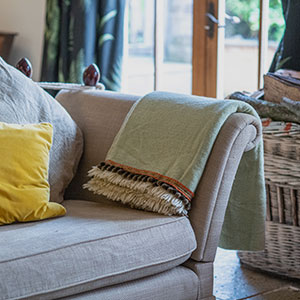 Cosy holiday cottage sitting room with Beili Glas textiles. Sleeps eight people